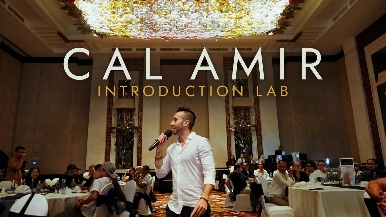 Cal Amir with a microphone in a full ballroom, the speaker reel poster